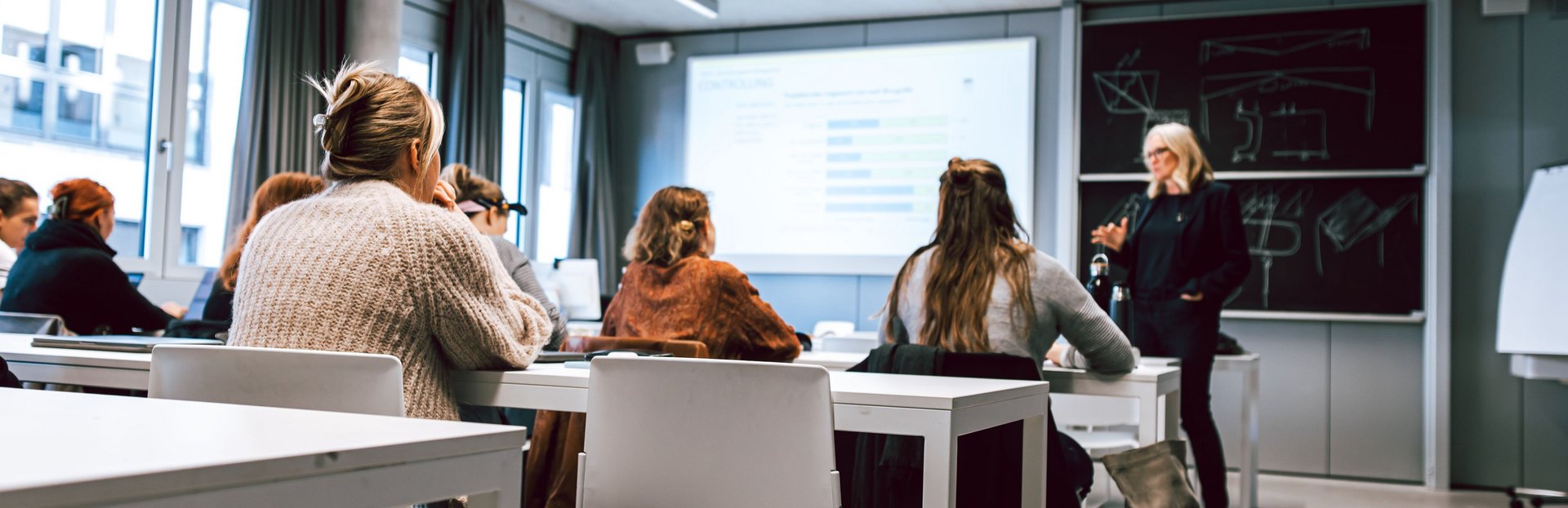 Professorin hält eine Lehrveranstaltung vor Studierenden