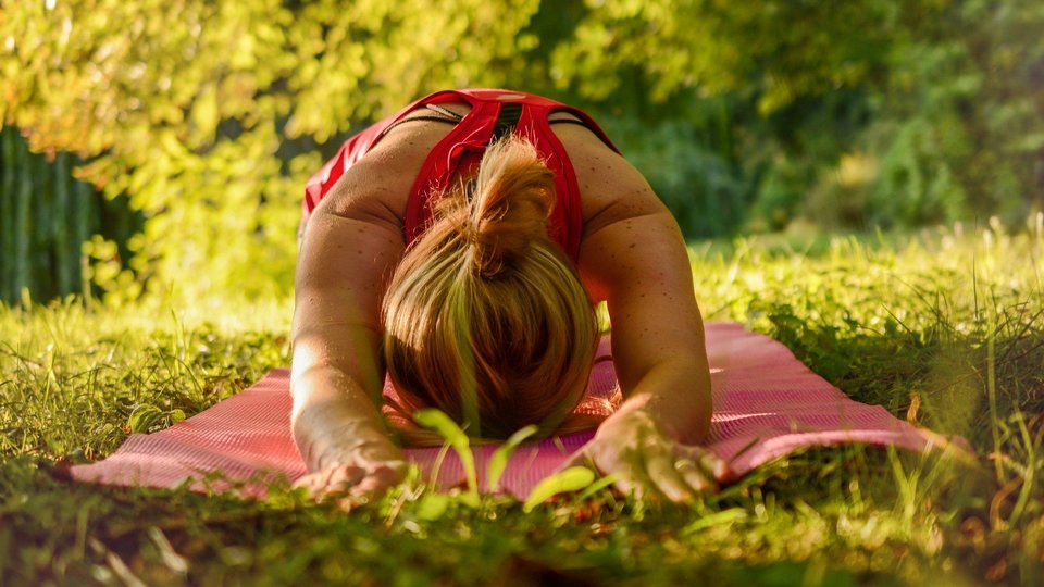 Eine Studentin macht Yoga im Park