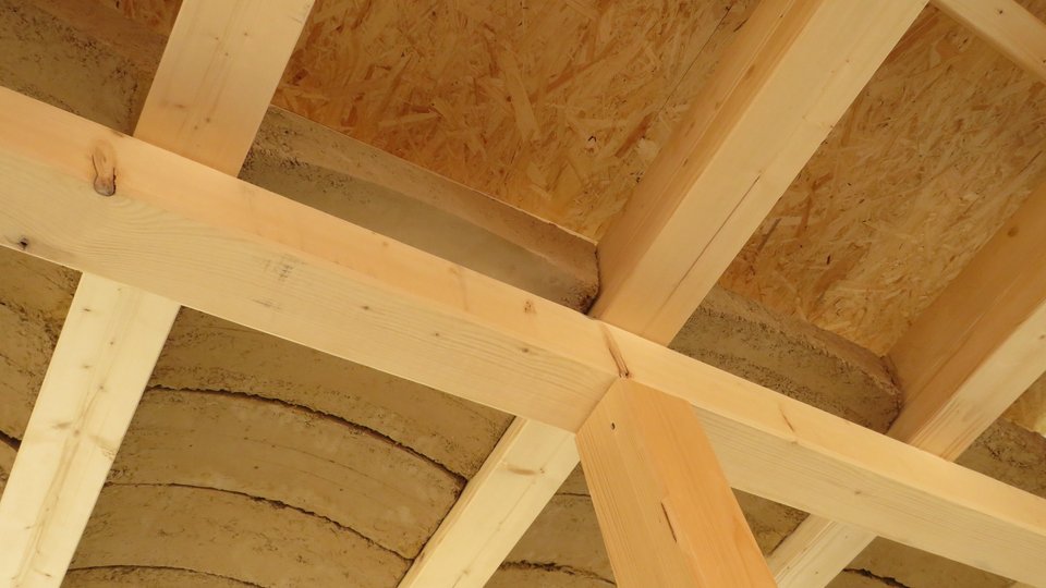 zu sehen ist eine Raumdeck mit Stützen und Trägern aus Holz sowie einer gewölbten Decke aus Lehmziegeln