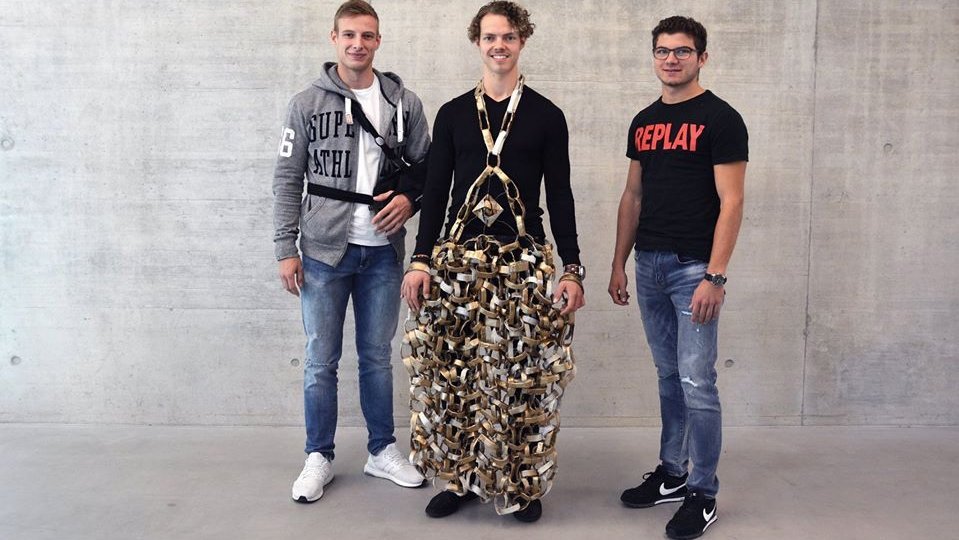 Drei Studierende präsentieren Kleider aus Papier 