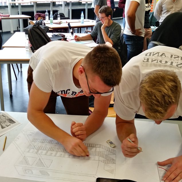 Zwei Studierende arbeiten an einer Zeichnung